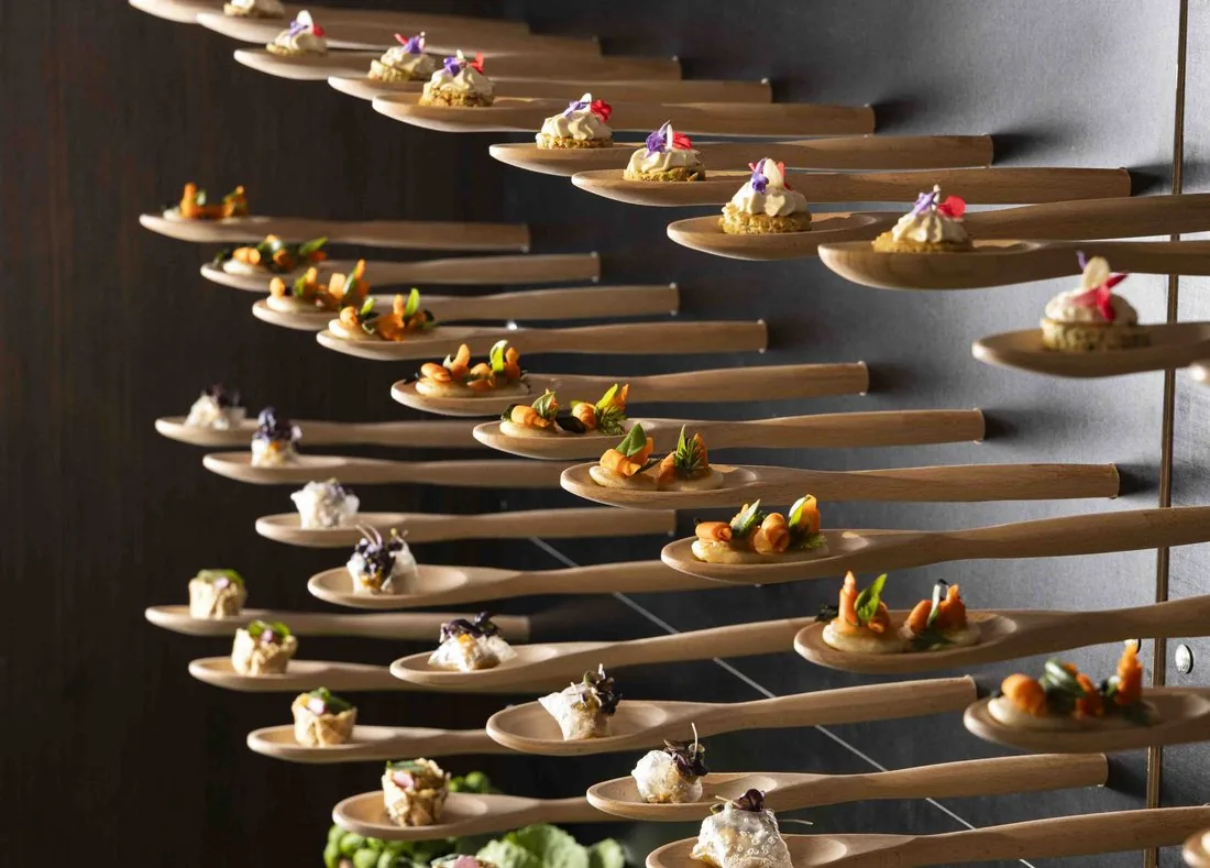 A suspended spoon installation displaying canapés from the See Dining Differently menu