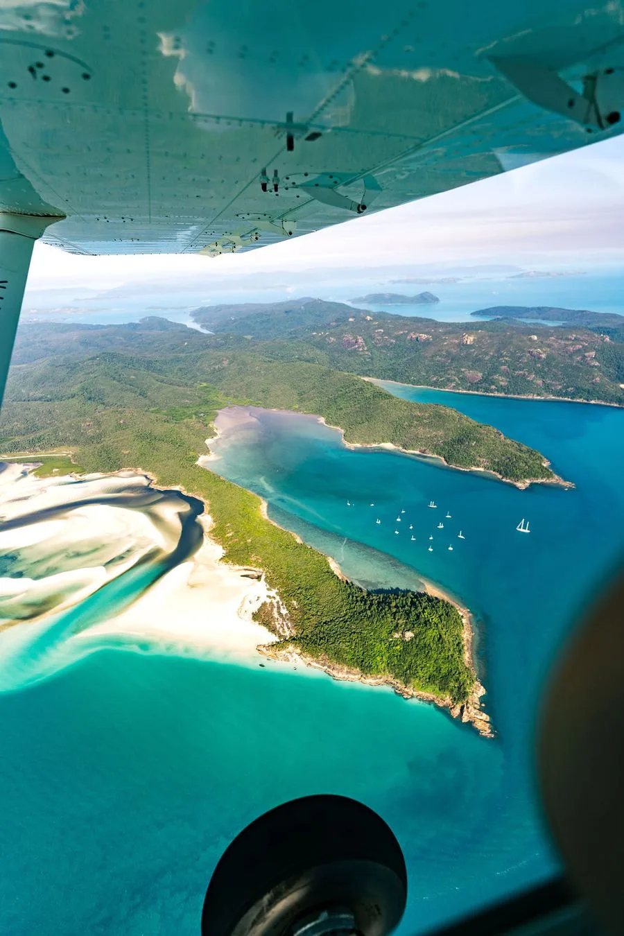 A view of the Whitsundays coastline from a light aircraft, with Whitehaven Beach and Hill Inlet below