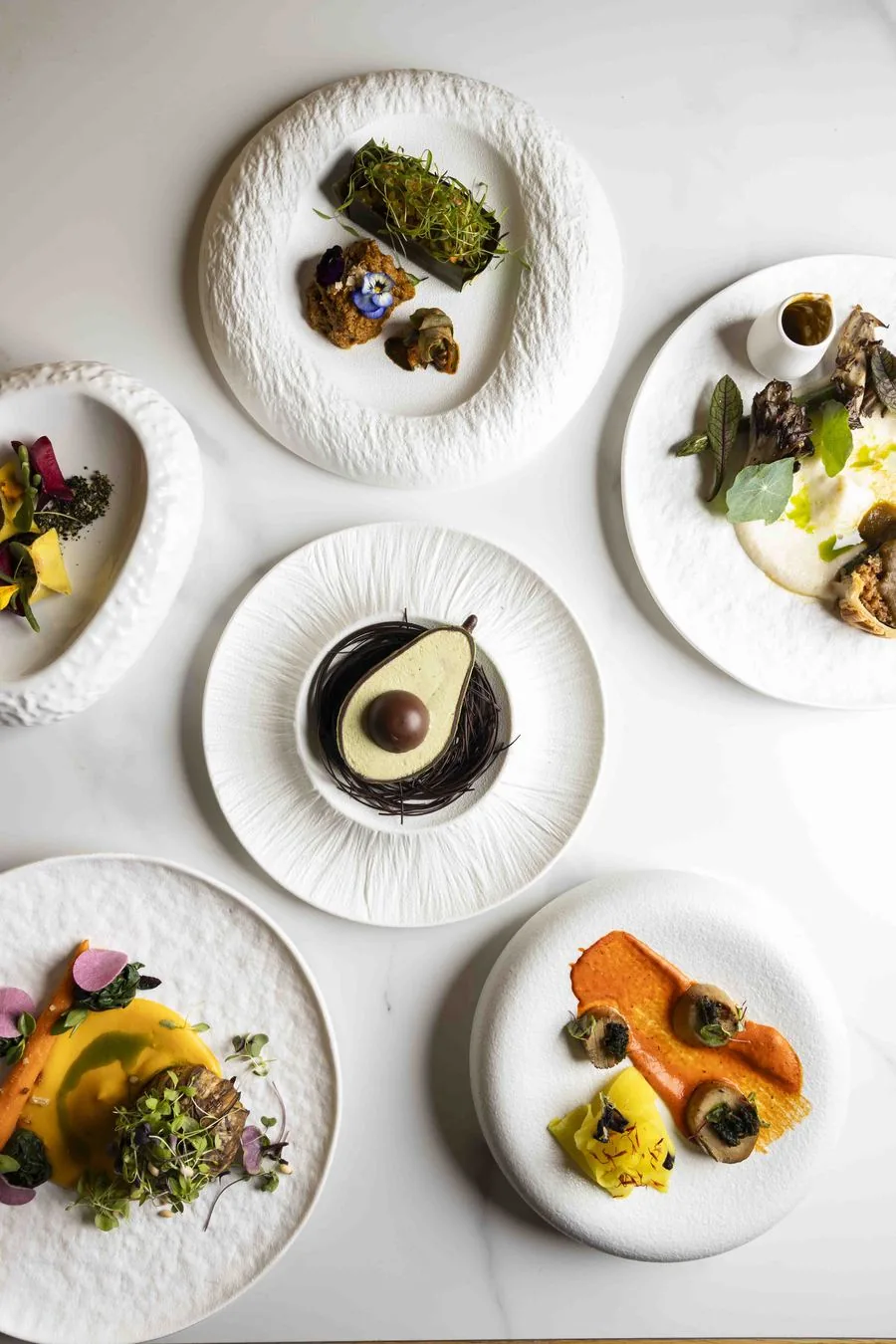 An overhead spread of courses from the See Dining Differently menu