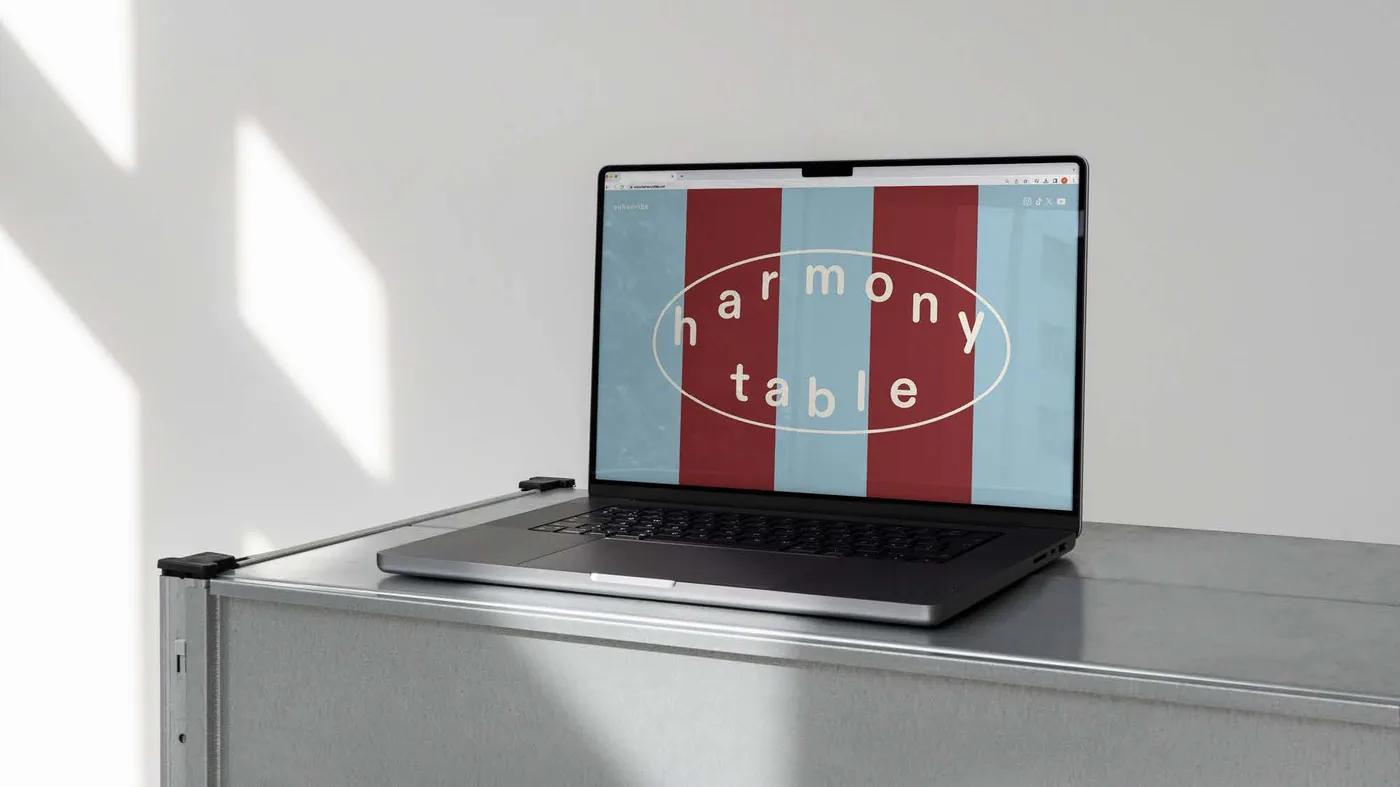 Harmony Table website shown on a laptop screen