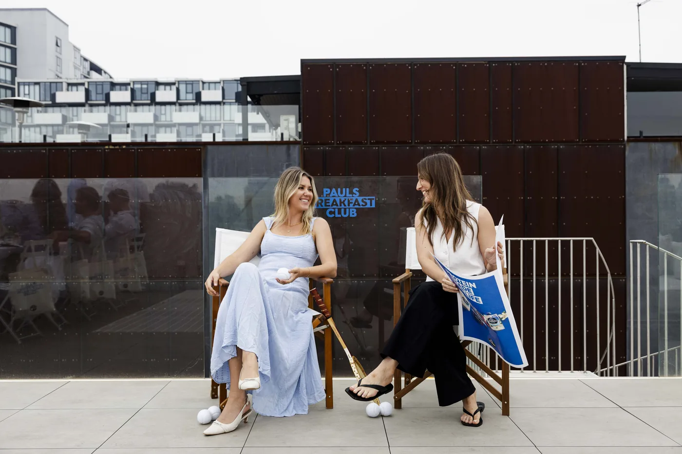 Guests seated in front of Paul's Breakfast Club branded signage