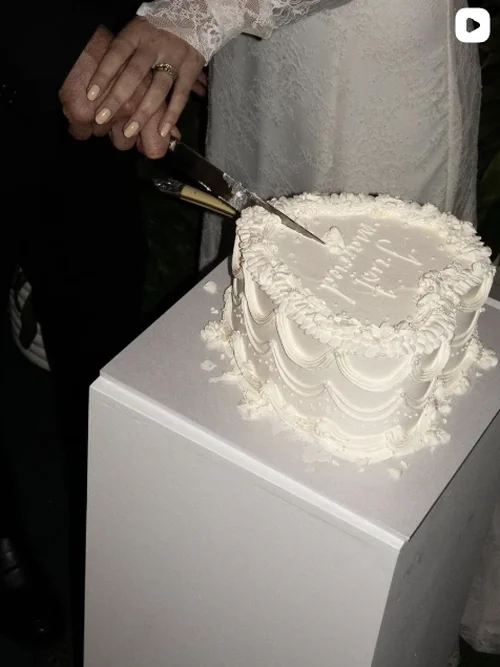 Made By Muse Instagram - Two people cutting a white heart-shaped cake